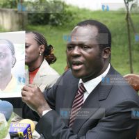 Presidential candidate Raphael Tuju holds the photo of Winnie Maru, director special projects