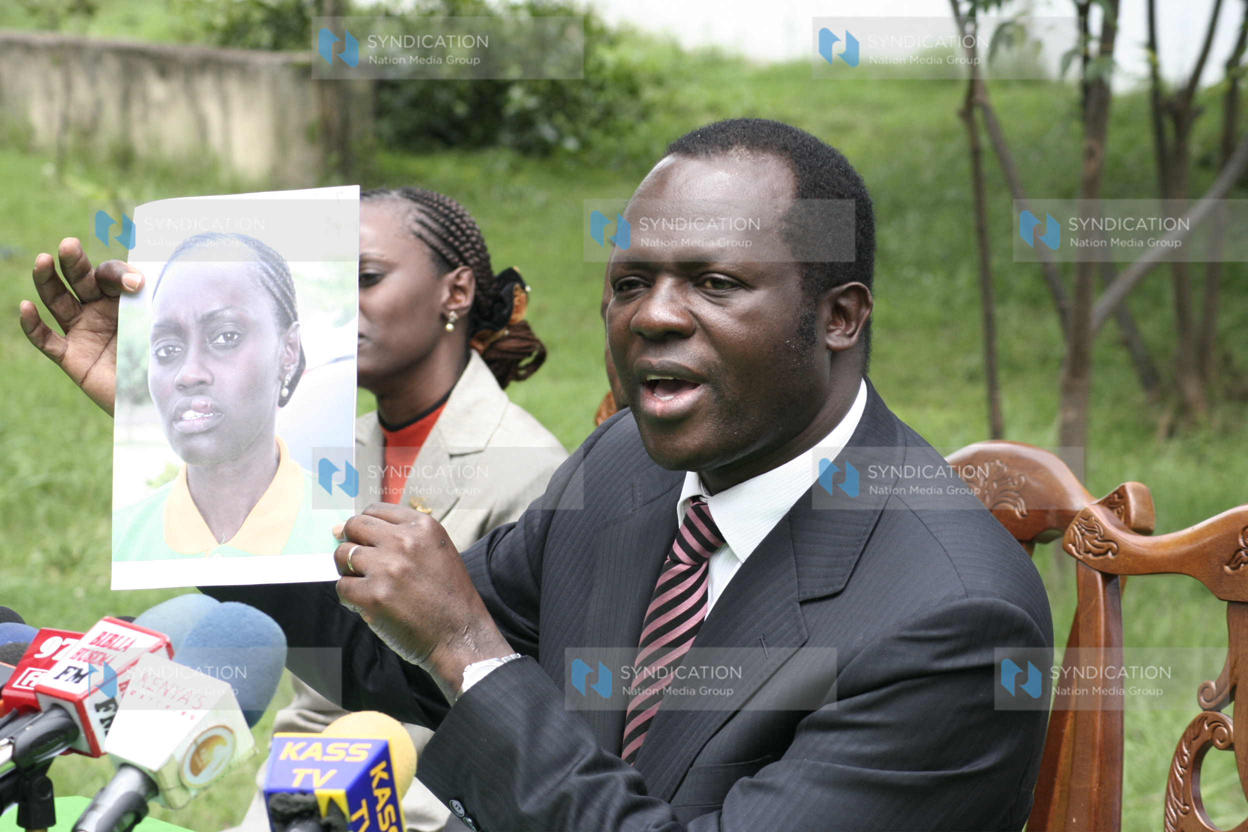 Presidential candidate Raphael Tuju holds the photo of Winnie Maru, director special projects