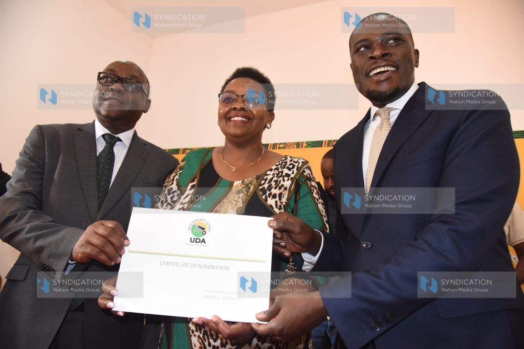 UDA Secretary General Veronica Maina handing over Certificate of nomination to Nairobi Gubernatorial candidate Johnson Sakaja and his running mate James Njoroge Muchiri
