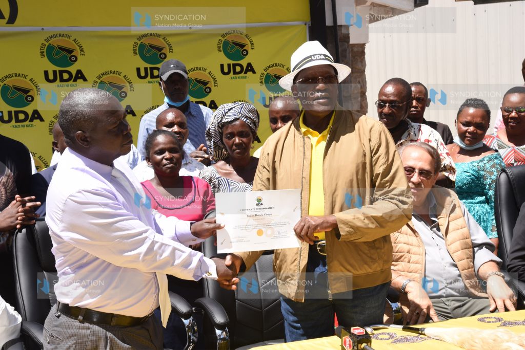 UDA Party Chairman Johnson Muthama hands a nomination certificate to Daniel Kimuyu