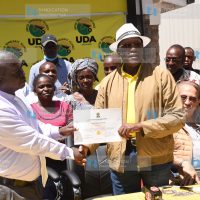 UDA Party Chairman Johnson Muthama hands a nomination certificate to Daniel Kimuyu