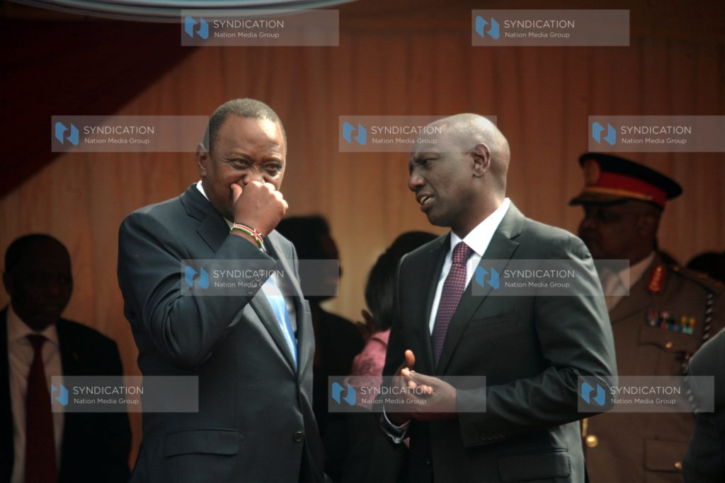 President Uhuru Kenyatta chats with Deputy President Willam Ruto