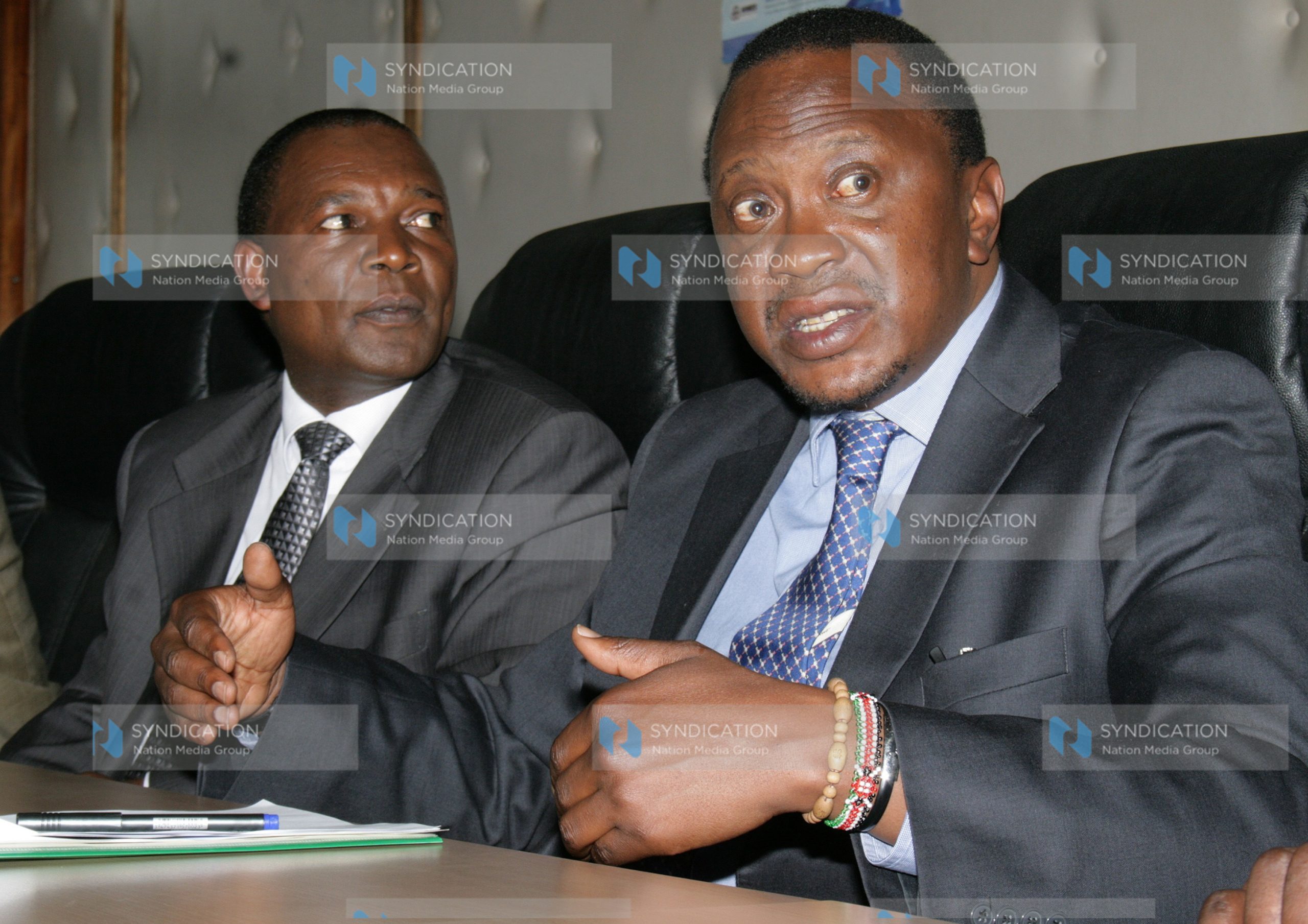 The deputy Prime minister and the minister for finance Uhuru Kenyatta flanked by the CBK governor Prof Njuguna Ndungu
