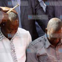 Deputy Prime Minster Uhuru Kenyatta with William Ruto are showered with oil during prayers