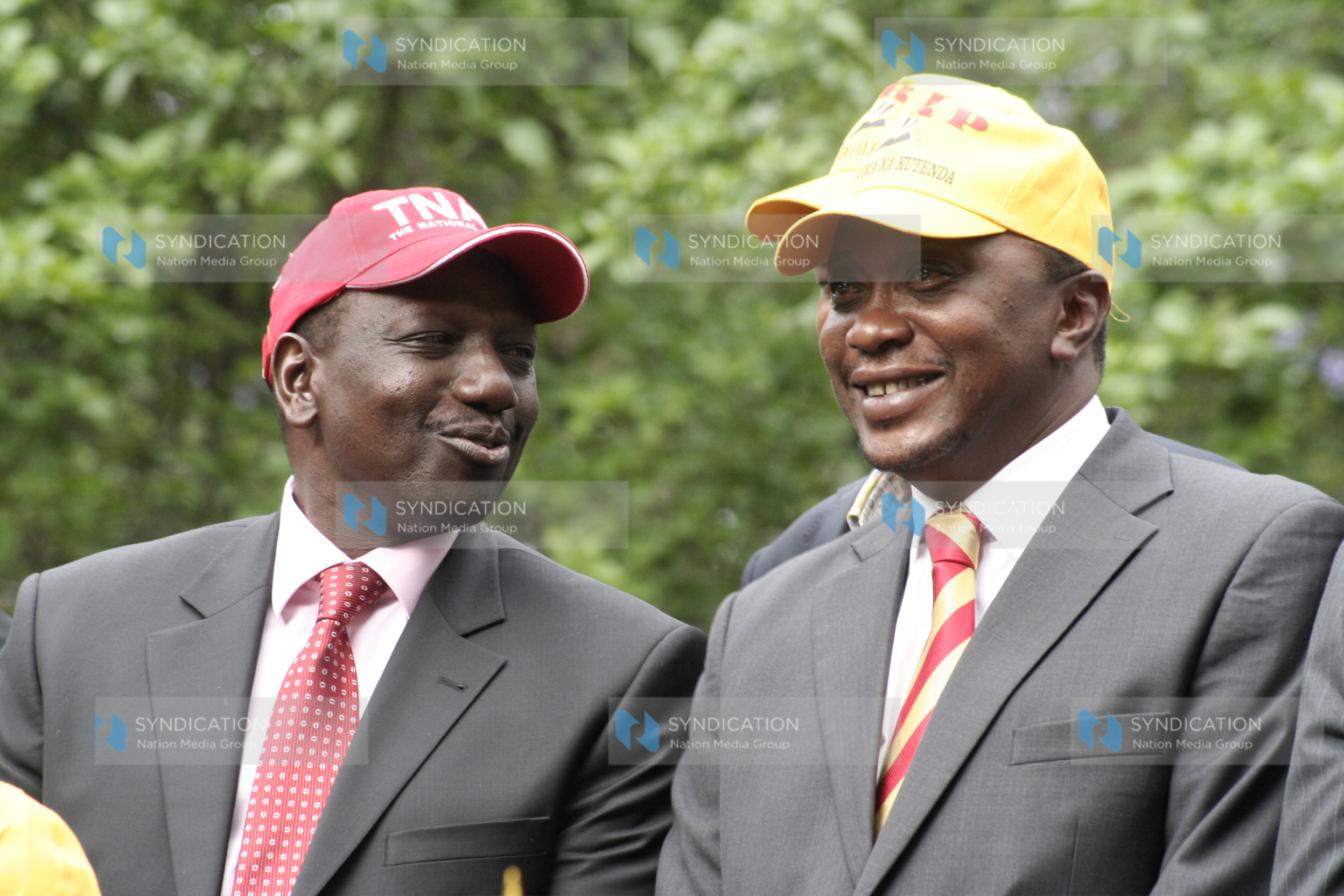 TNA presidential aspirant Uhuru Kenyatta chats with his running mate William Ruto