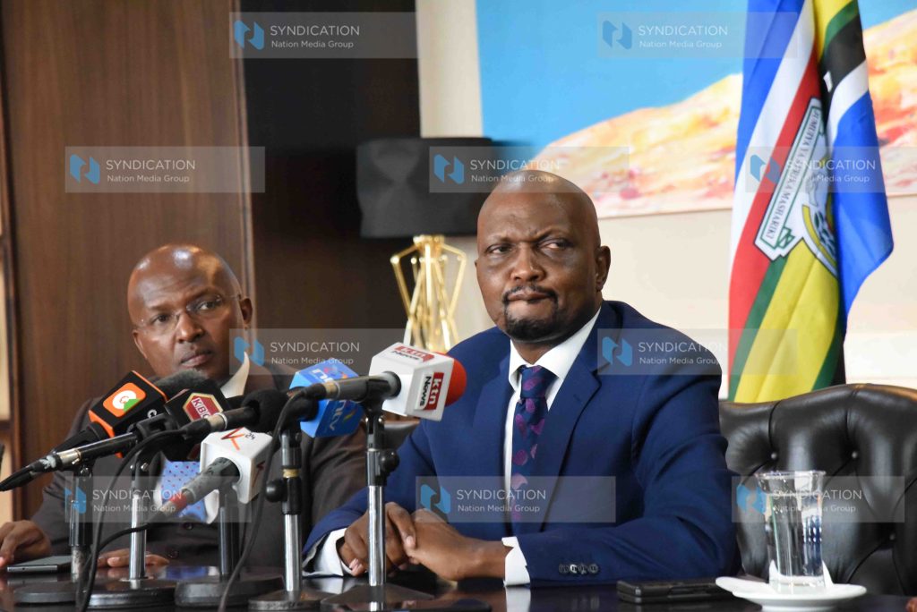 Trade Cabinet Secretary Moses Kuria flanked by advisor Dr Peter Mbae