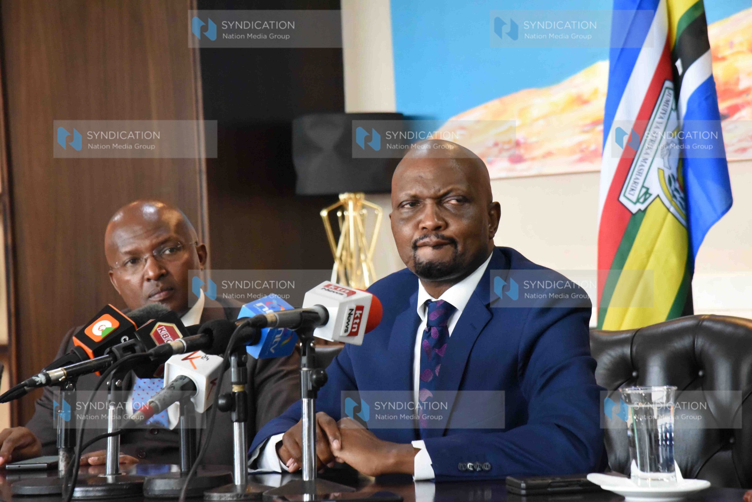 Trade Cabinet Secretary Moses Kuria flanked by advisor Dr Peter Mbae