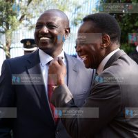 Deputy President William Ruto shares a joke with Education Cabinet Secretary Jacob Kaimenyi