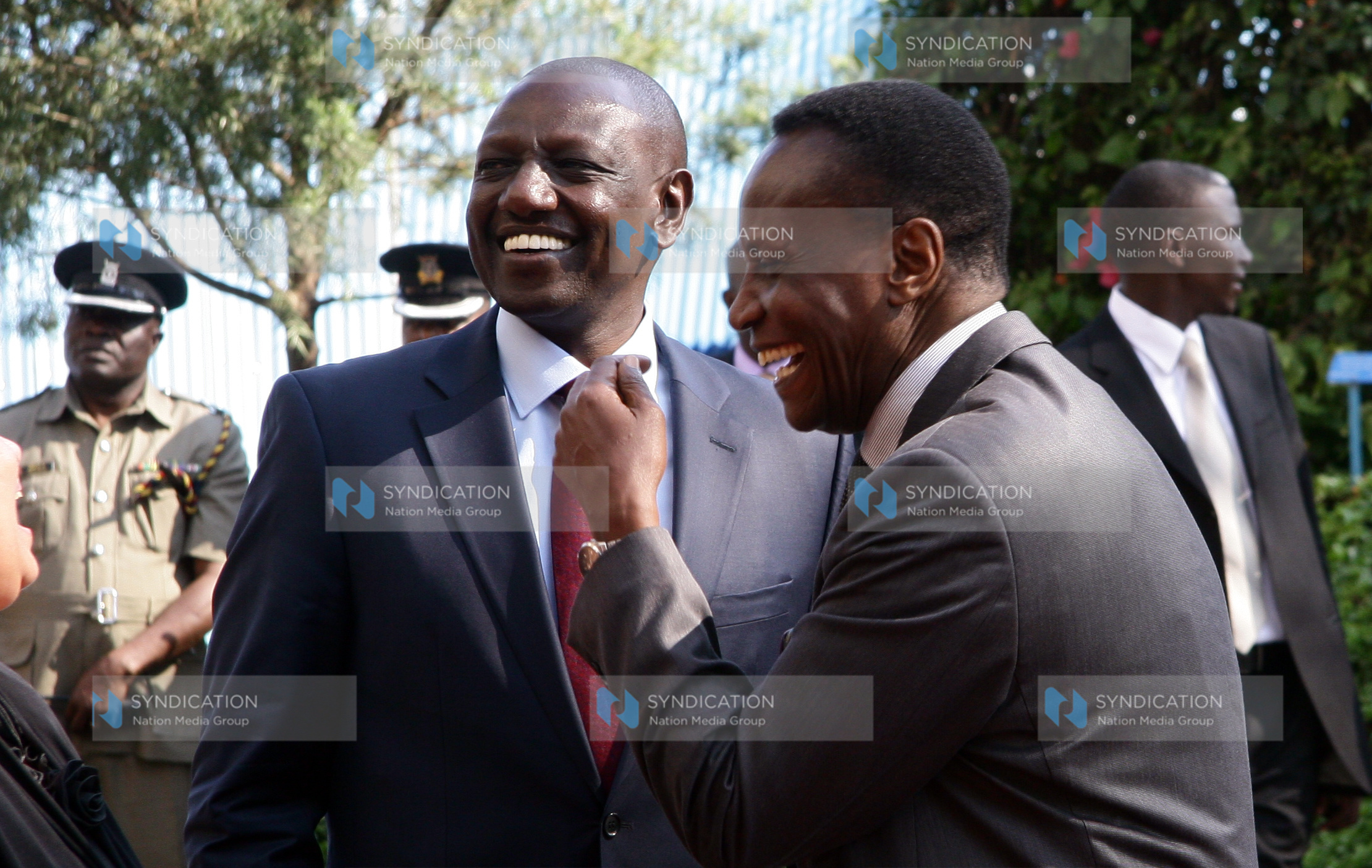 Deputy President William Ruto shares a joke with Education Cabinet Secretary Jacob Kaimenyi