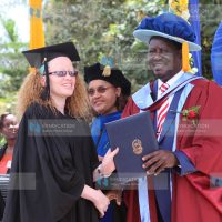 CORD leader Raila Odinga presents awards to graduands during the USIU-A Class of 2015 graduation ceremony