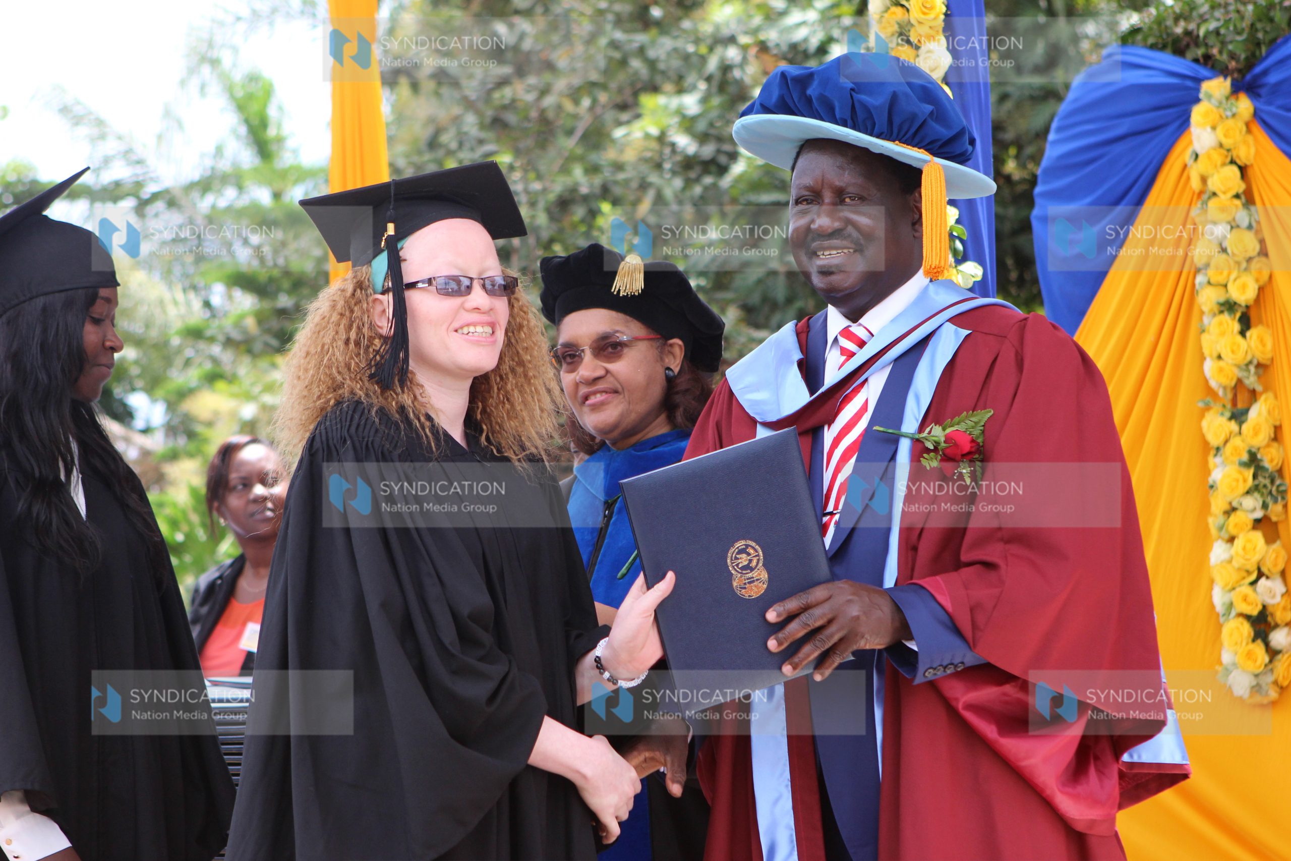CORD leader Raila Odinga presents awards to graduands during the USIU-A Class of 2015 graduation ceremony