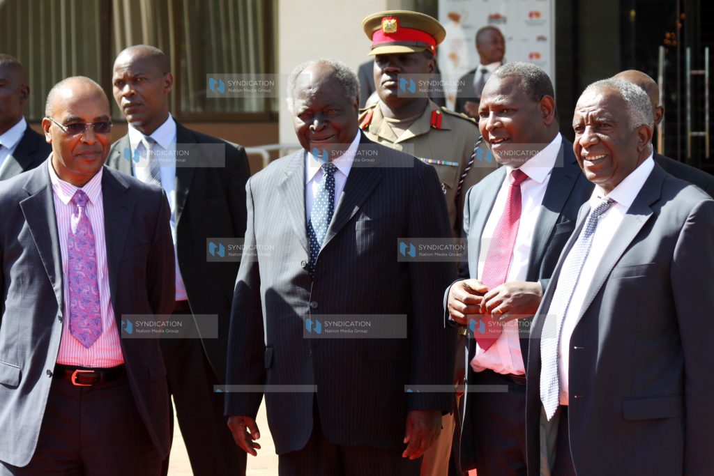 President Mwai Kibaki (second left) chats with Equity Bank Chief Executive Officer James Mwangi
