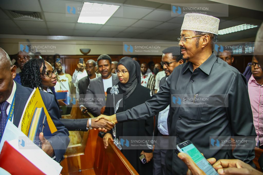 Eldas Member of Parliament Adan Keynan shakes hands with Law Society of Kenya President Faith Odhiambo