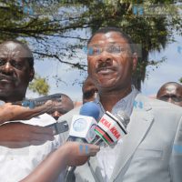 Senator Moses Wetangula addresses the media, flanked by Prime Minister Raila Odinga and Paul Otuoma