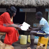 Homa Bay Woman Representative Gladys Wanga chats with Austin Omondi Arunga who scored 407 marks in the 2019 KCPE exams