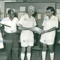 Mr R.F. Harrison (centre), Mombasa director of the British Council, hands over road-safety films