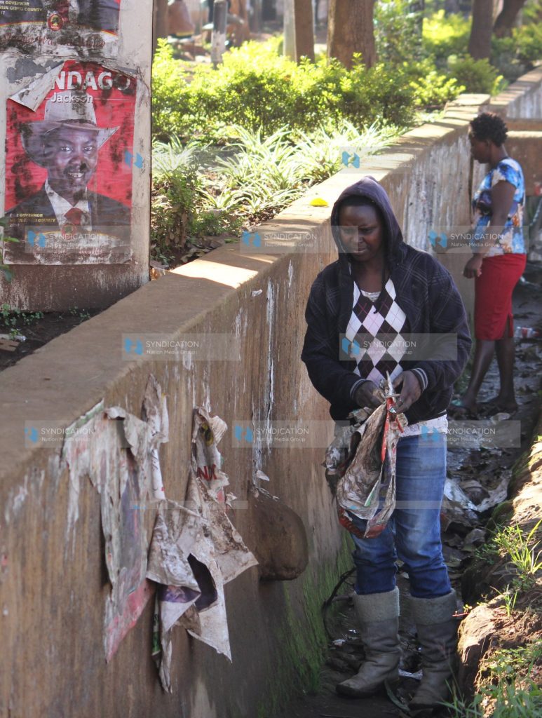 Workers from Uasin Gishu County remove campaign posters