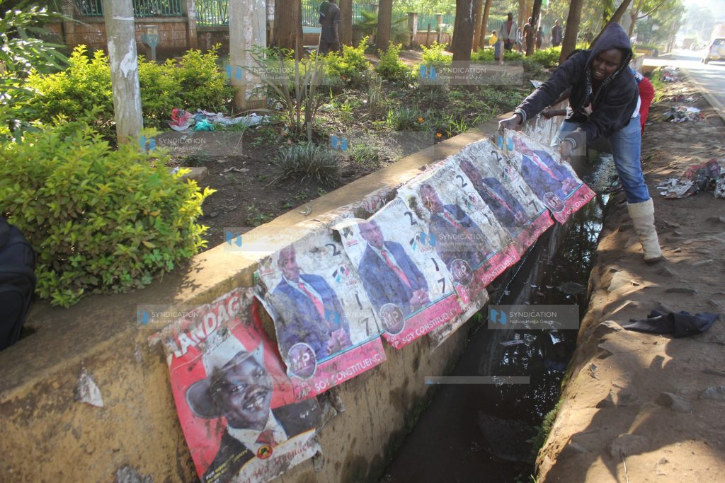 Workers from Uasin Gishu County remove campaign posters for various candidates