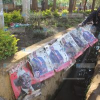 Workers from Uasin Gishu County remove campaign posters for various candidates