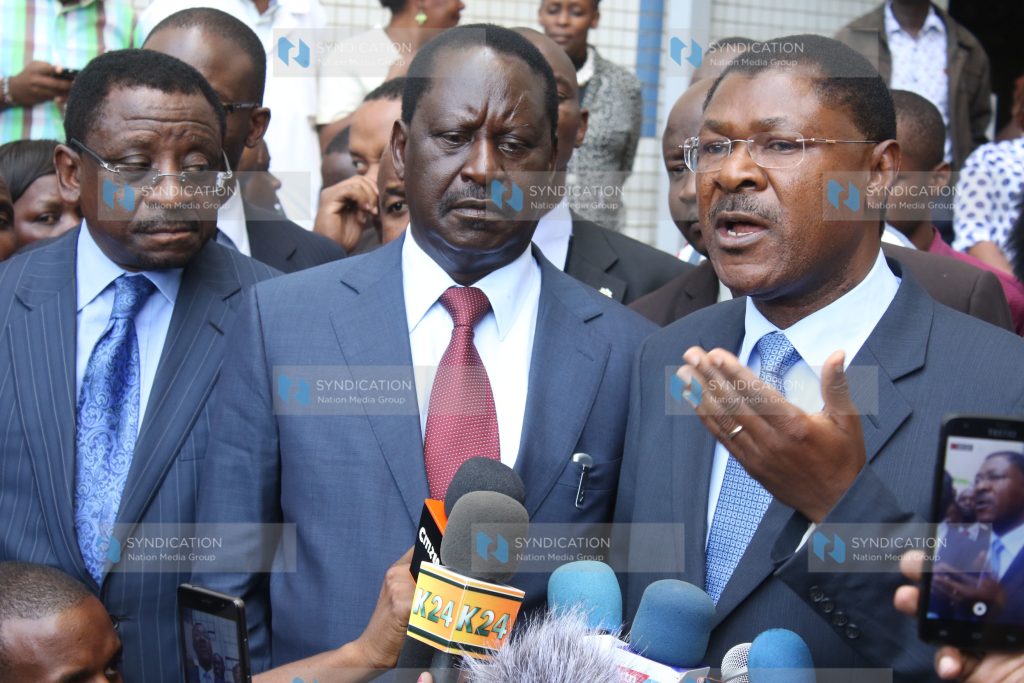 Opposition leaders led by Raila Odinga (center) address the media