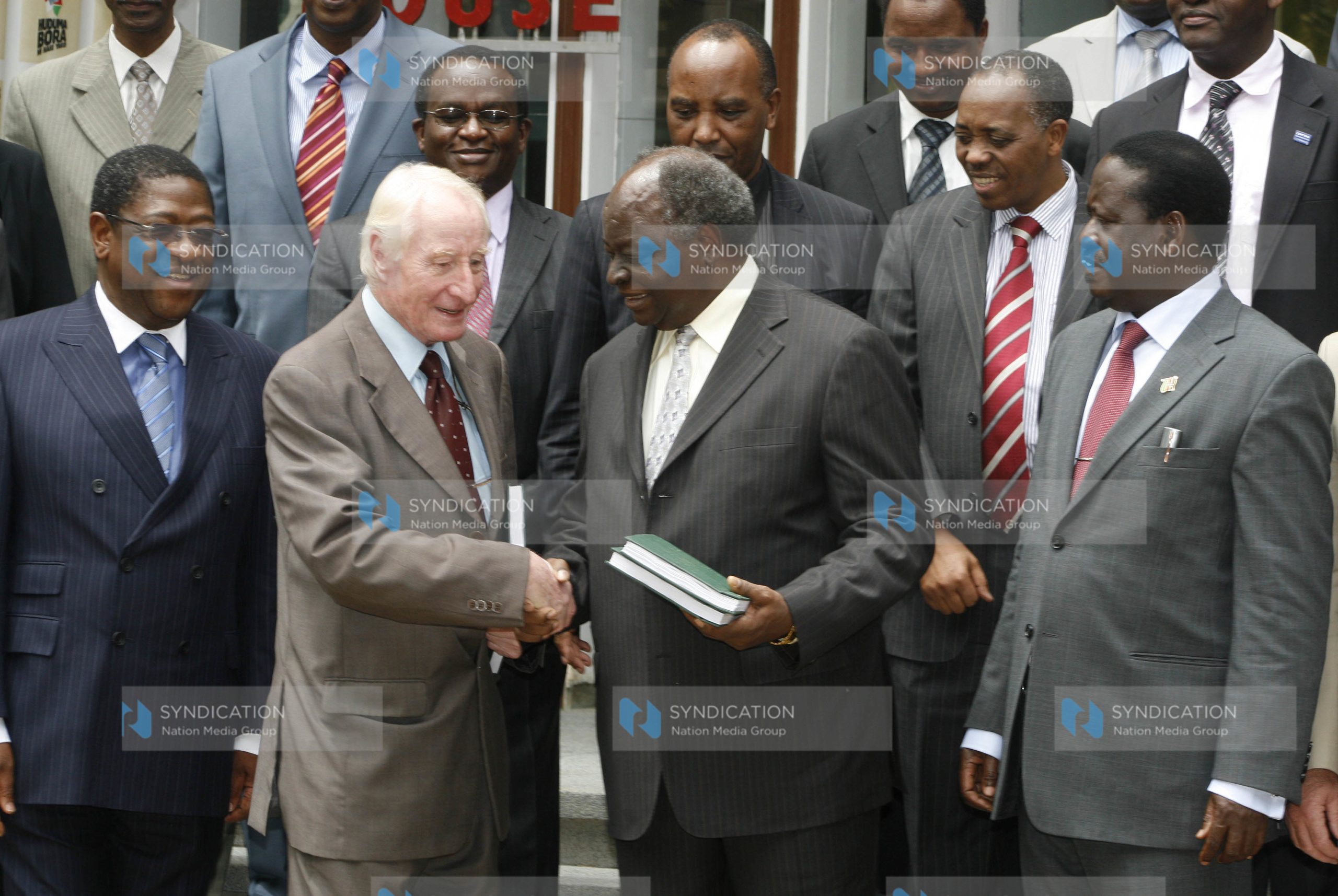 President Mwai Kibaki receives a report on police reforms