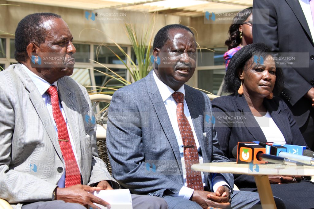 Opposition Chief Raila Odinga [center] addresses the media at his Capitol Hill