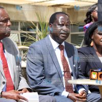 Opposition Chief Raila Odinga [center] addresses the media at his Capitol Hill