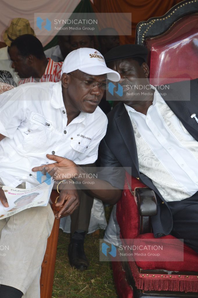 Boni Khalwale whispers a word to Cord leader Raila Odinga