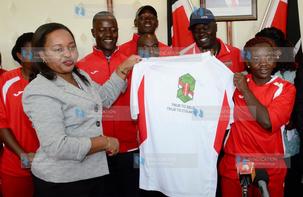 Devolution and Planning Cabinet Secretary Anne Waiguru present training and playing kits to the Harambee Starlets