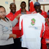 Devolution and Planning Cabinet Secretary Anne Waiguru present training and playing kits to the Harambee Starlets