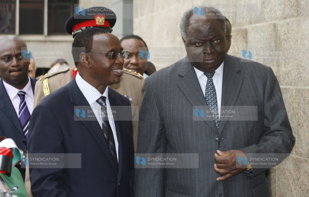 Standard Chartered Bank chairman Wilfred Kiboro takes President Mwai Kibaki round the newly inaugurated Standard Chartered Bank Head office