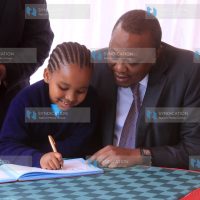 President Uhuru Kenyatta having a chat with Domita Nyambura a pupil from Karen C primary school