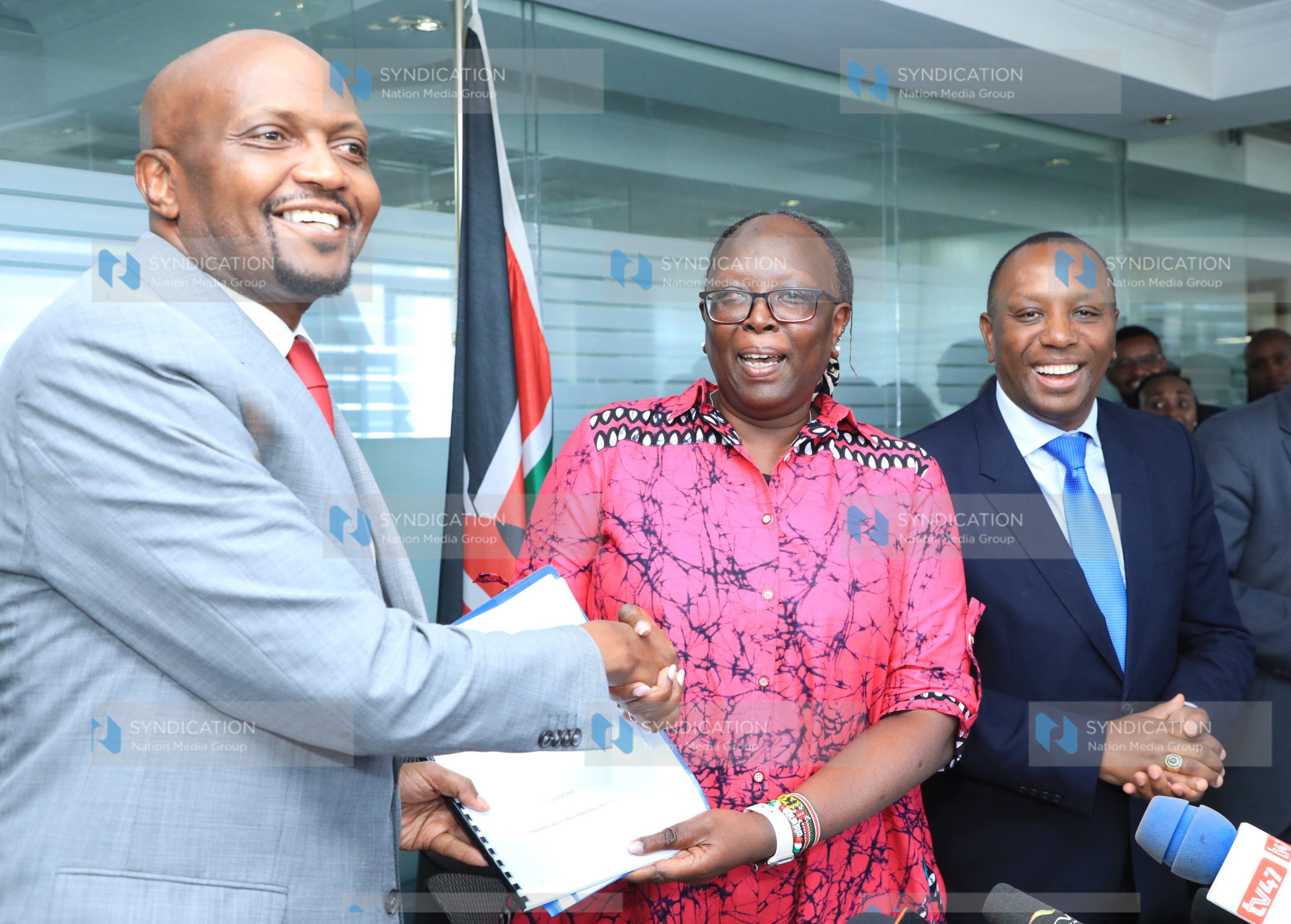 Trade Cabinet Secretary Moses Kuria is handed over some documents by the outgoing Trade CS Betty Maina