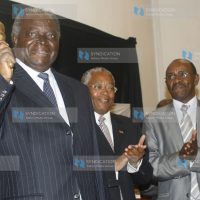 President Mwai Kibaki flanked with the Trade Minister Chirau Ali Mwakwere and Uchumi chief executive officer Jonathan Ciano