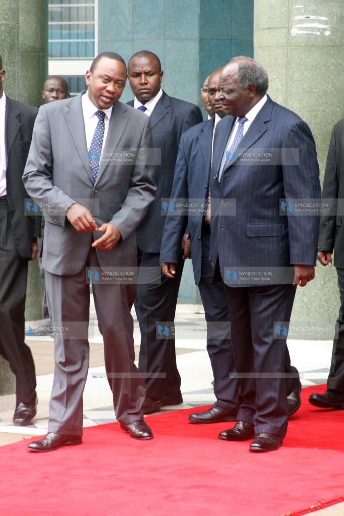 President Mwai Kibaki and Deputy prime minister and minister for finance Uhuru Kenyatta leaves Nation Centre after the Uchumi Bond offer bell ringing ceremony
