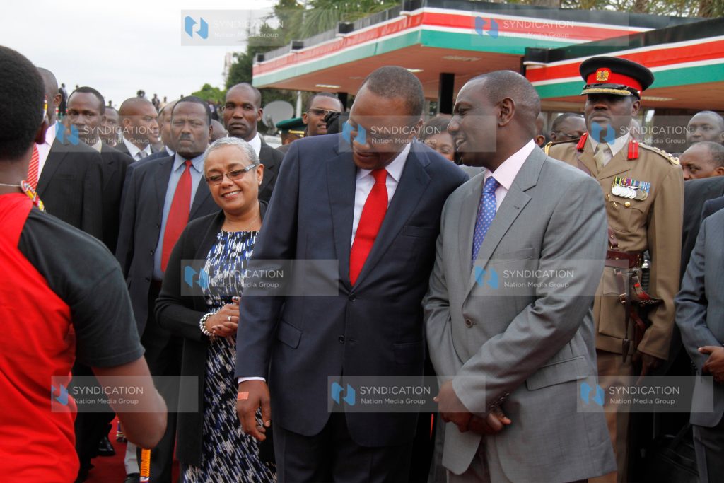 President Uhuru Kenyatta having a word with Deputy President William Ruto as First Lady, Margret Kenyatta looks on