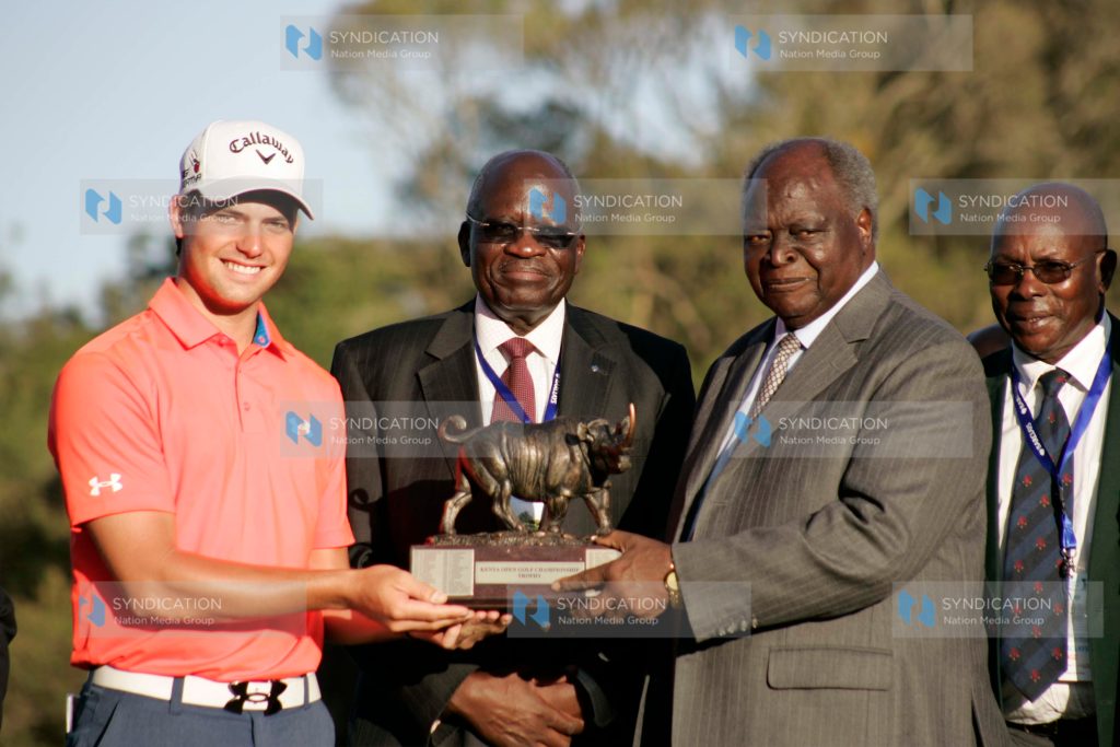 South Africa Haydn Porteous display's Barclays Kenya Open winner's Trophy flanked by Barclays Bank chairman Francis Okello and Kenya Golf Union patron