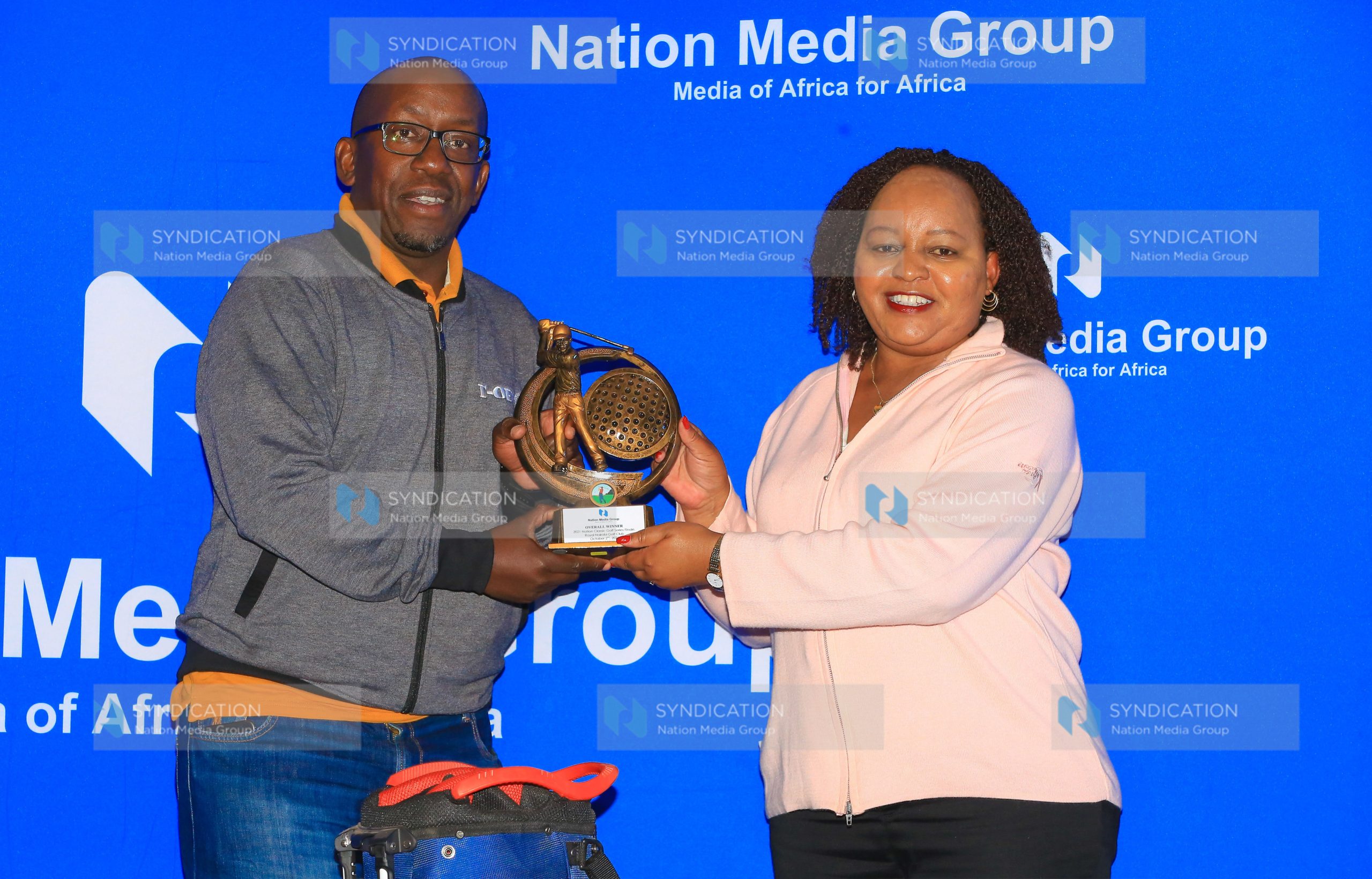 Kirinyaga Governor Anne Waiguru hands over the Nation Classic overall award to winner Joseph Nyagah