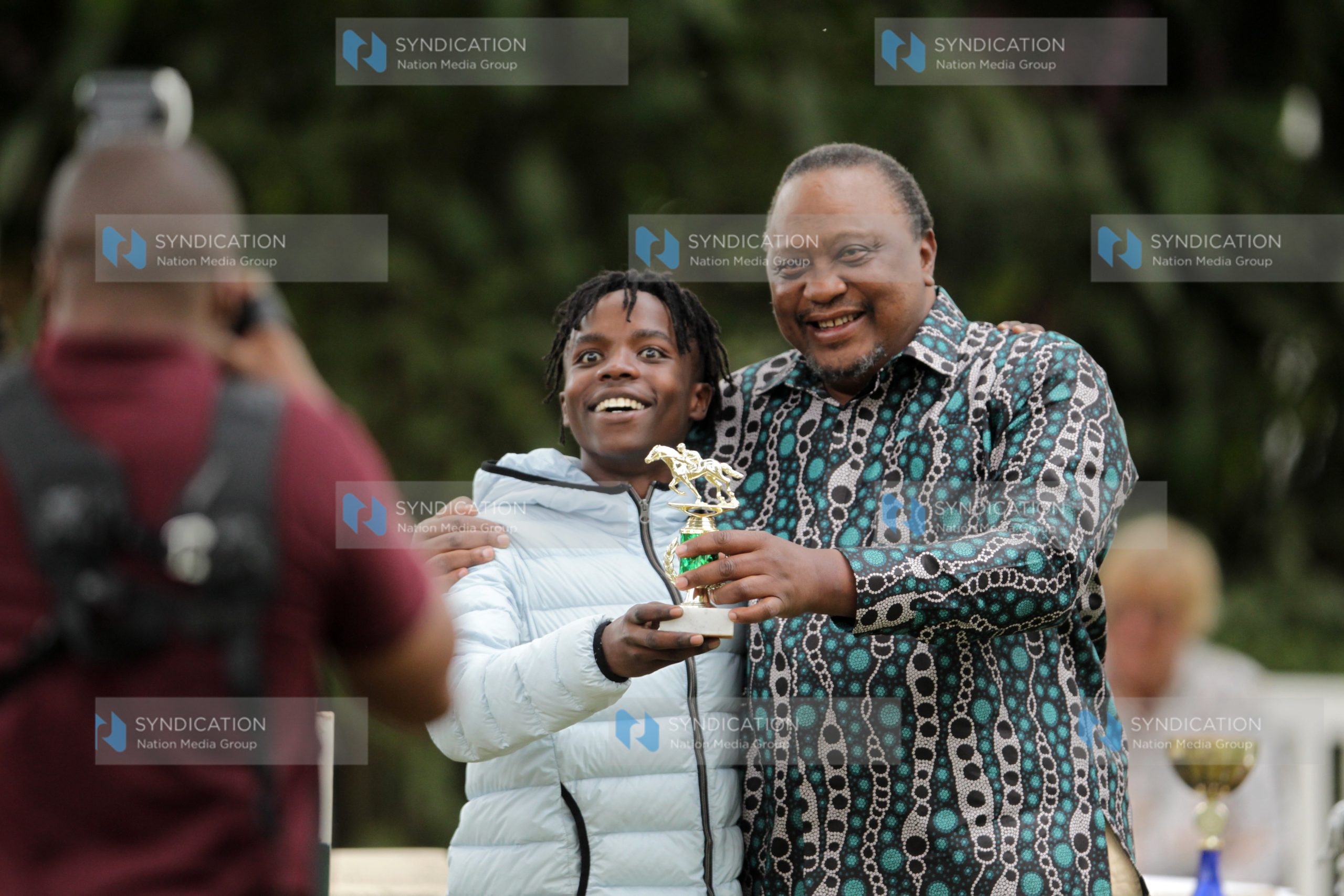 Jockey Micheal Fundi with Retired President Uhuru Kenyatta