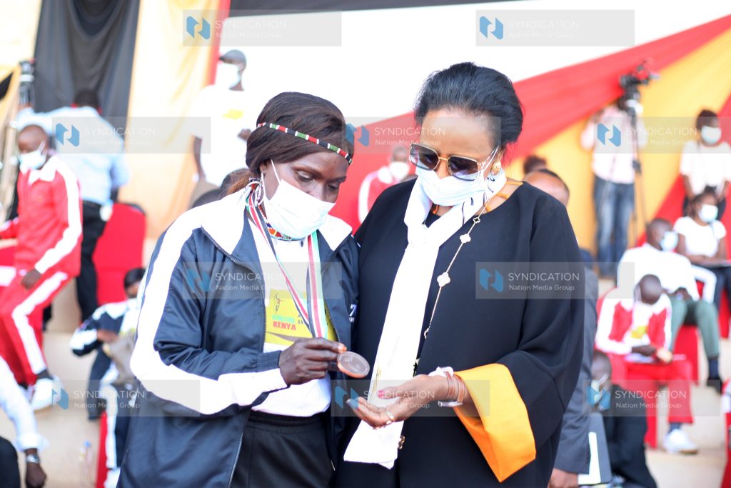 Former National Athlete Rose Tata-Muya show her 1979 Africa Championship silver medal to Sports Cabinet Secretary Amina Mohammed