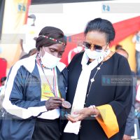 Former National Athlete Rose Tata-Muya show her 1979 Africa Championship silver medal to Sports Cabinet Secretary Amina Mohammed