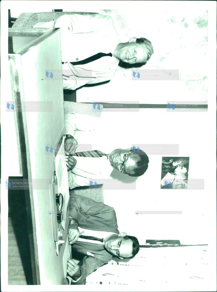 Signing an agreement on a £2 Million loan from Britain for the East African Common Services in Dar es Salaam