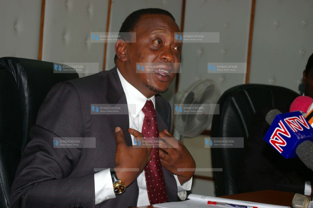 Trade Minister Uhuru Kenyatta (left) addresses a press briefing