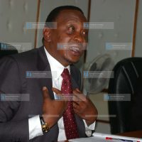 Trade Minister Uhuru Kenyatta (left) addresses a press briefing