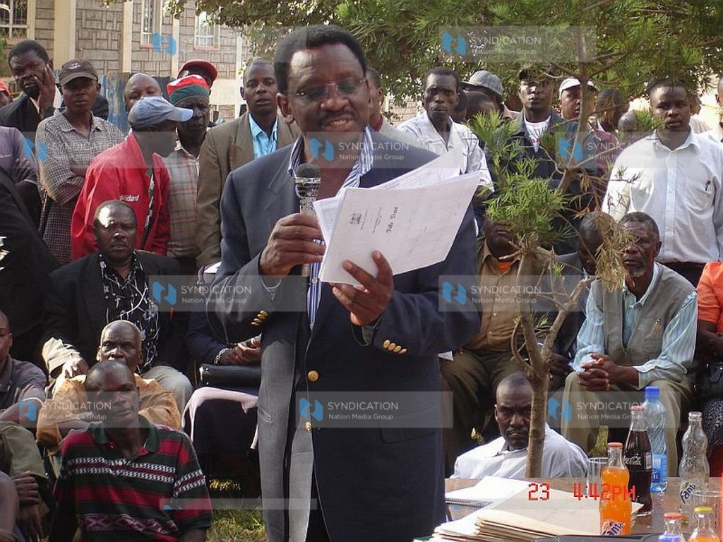 The Minister for Lands Mr. James Orengo displaying a copy of fake title deeds