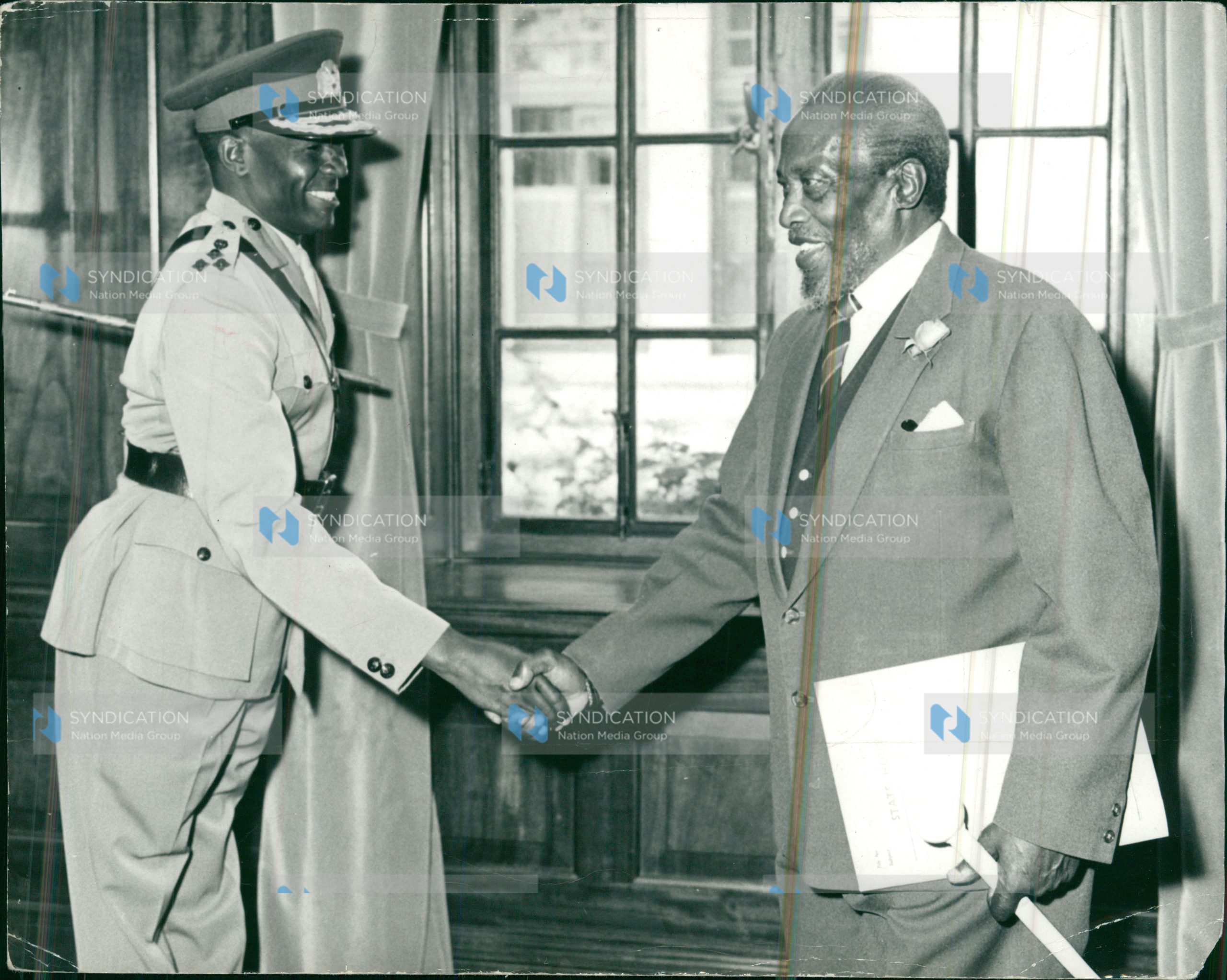 President Mzee Jomo Kenyatta congratulates Brig. Joseph Musyimi Ndolo (left)
