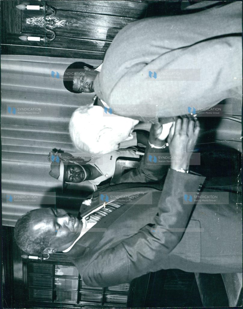 President Daniel Arap Moi invests Mr. Humphrey Slade (right) as a Knight of Grace of the Most Venerable Order of the Hospital of St. John