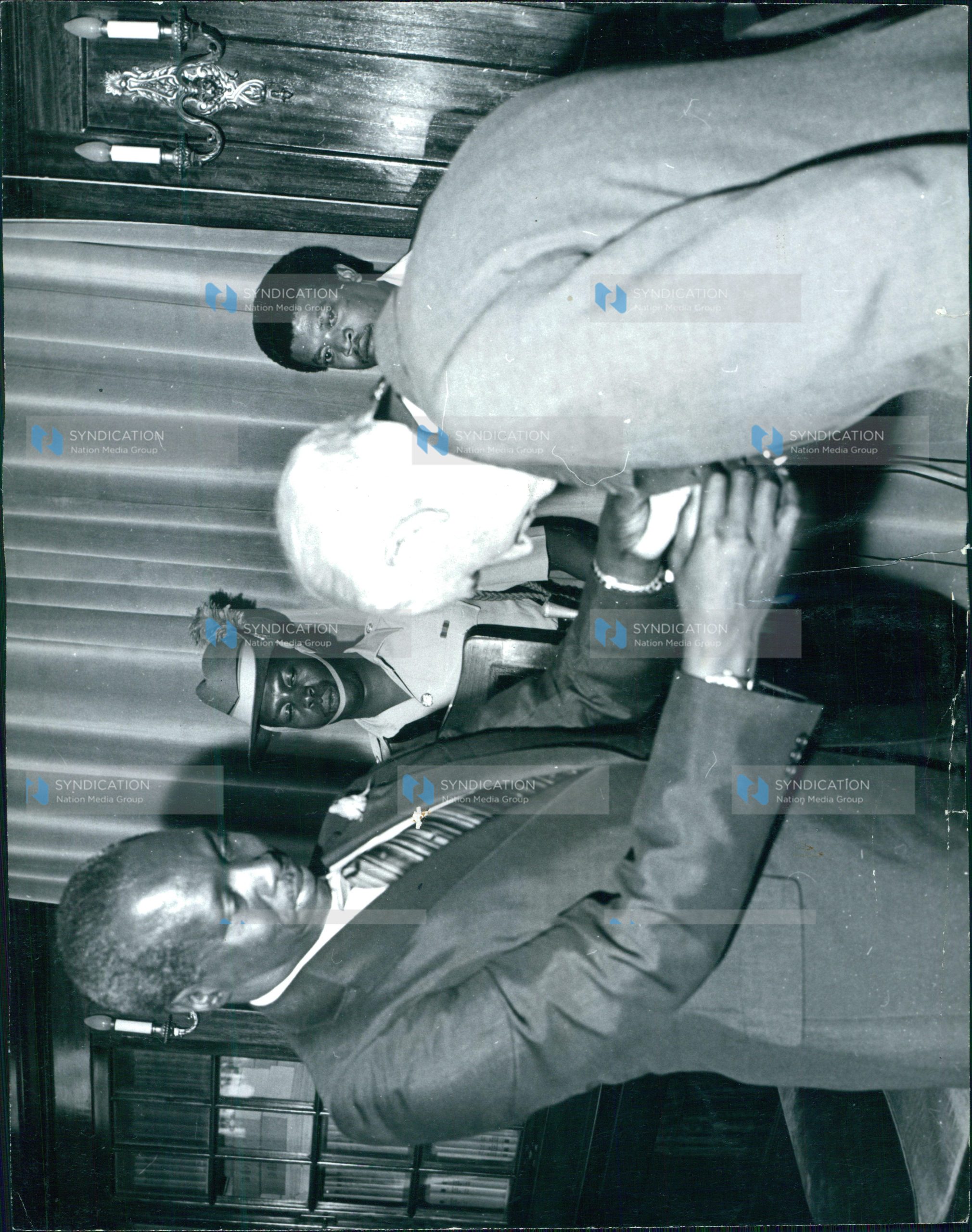 President Daniel Arap Moi invests Mr. Humphrey Slade (right) as a Knight of Grace of the Most Venerable Order of the Hospital of St. John