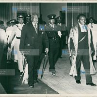 Mzee Jomo Kenyatta (left) is escorted into the Parliament Buildings
