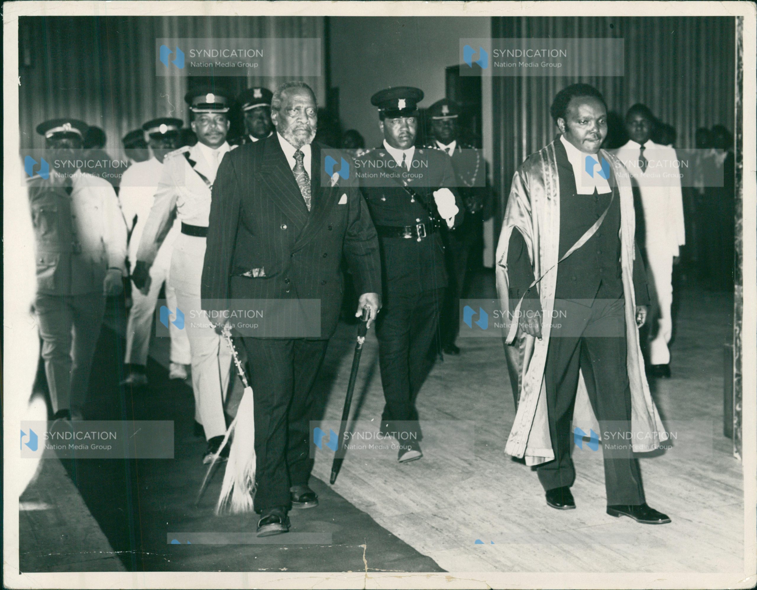 Mzee Jomo Kenyatta (left) is escorted into the Parliament Buildings